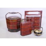 A Chinese three section food container with lacquered decoration, plaited cane handle with metal