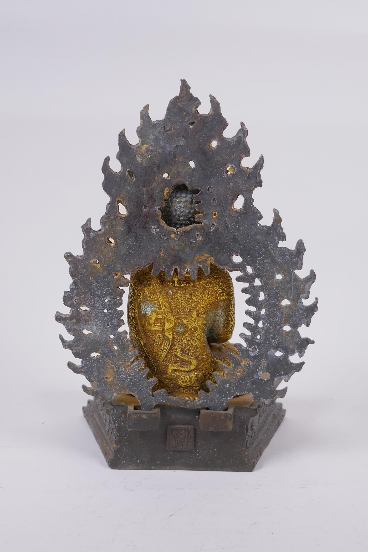 A Sino Tibetan gilt bronze figure of Buddha seated on a dias, Chinese 4 character mark verso - Image 4 of 7