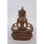 A Sino Tibetan gilt and coppered bronze Buddha seated, and holding a stupa, 22cm high