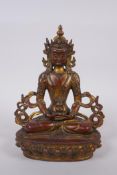 A Sino Tibetan gilt and coppered bronze Buddha seated, and holding a stupa, 22cm high