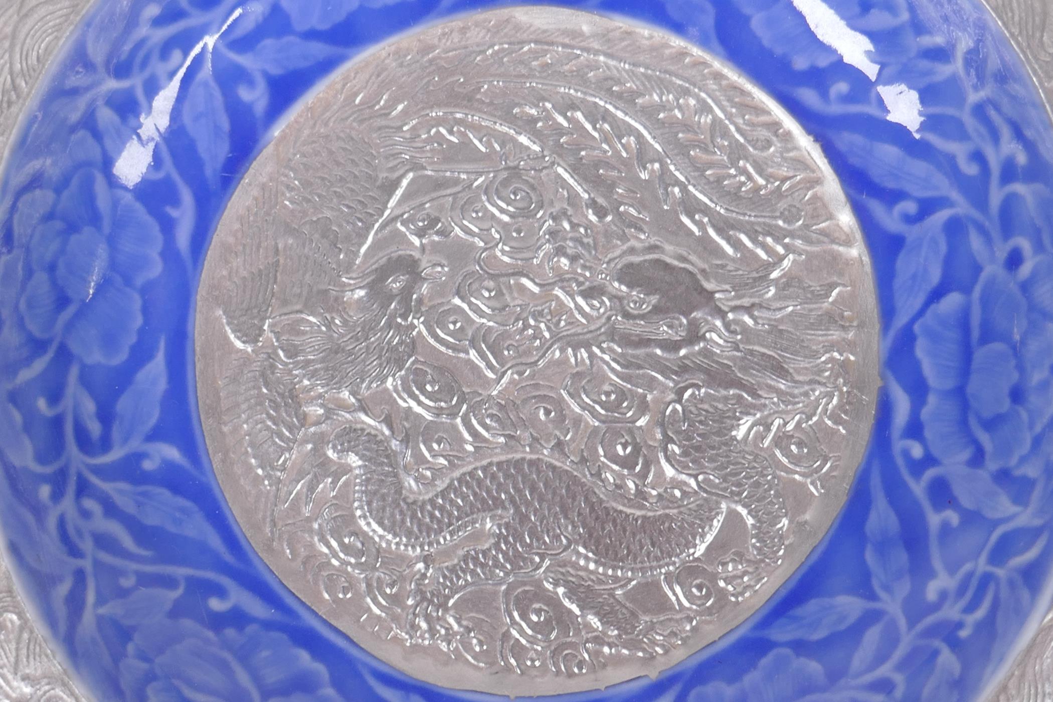 A Chinese blue and silver glazed porcelain dish with lobed rim, decorated with a dragon, phoenix and - Image 2 of 5