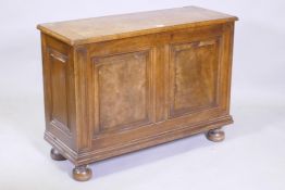 A figured mahogany blanket box/coffer, with lift up top and double fielded panel front, raised on