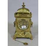A C19th continental gilt brass mantel clock, the case with lion mask ring handles and raised