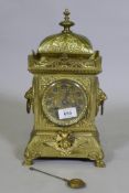 A C19th continental gilt brass mantel clock, the case with lion mask ring handles and raised