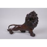 A filled bronzed metal figure of a lion, 26cm long