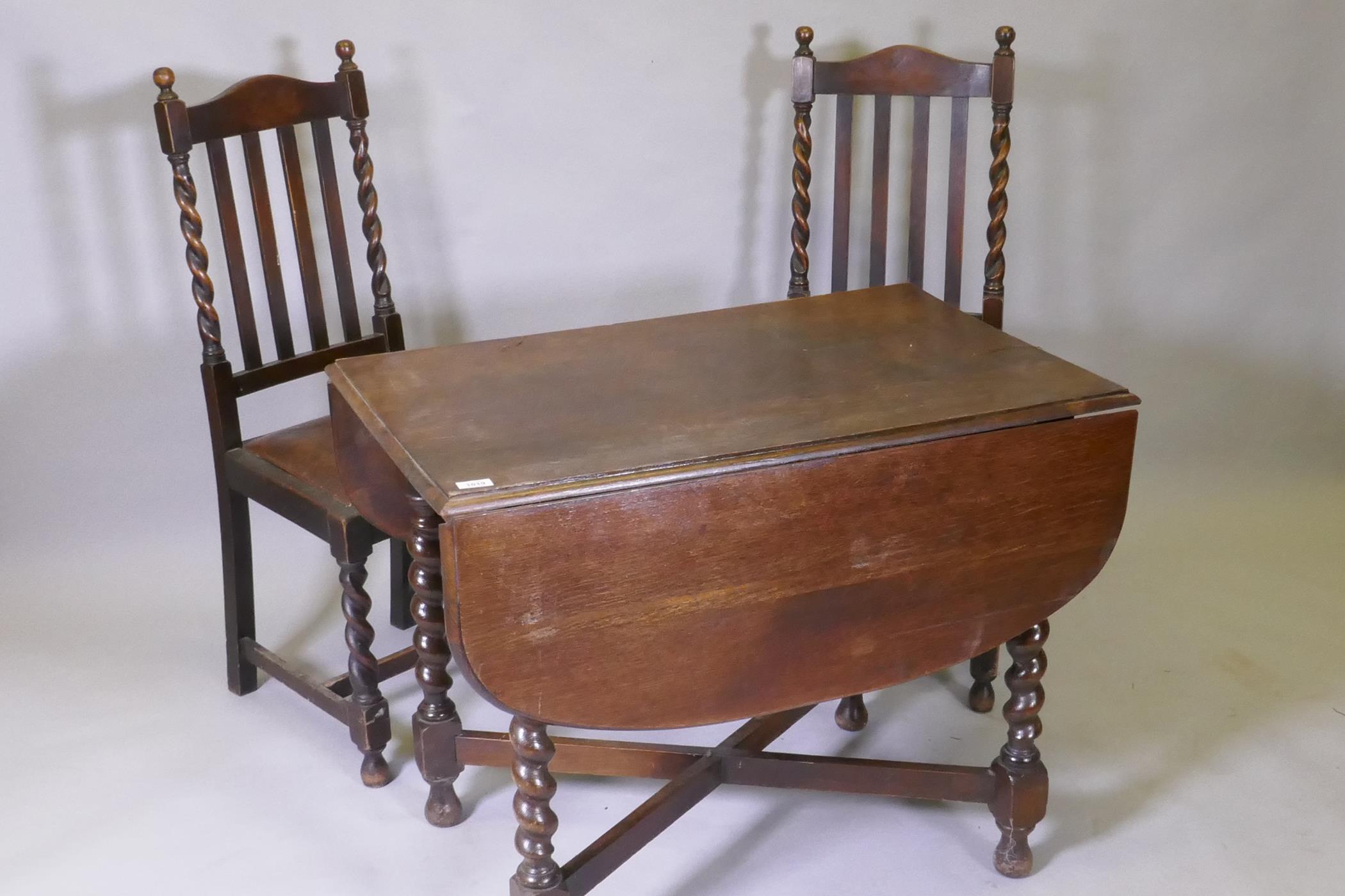 A Victorian oak drop leaf table, raised on barley twist supports and two chairs, 60 x 91 x 73cm - Image 2 of 2