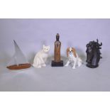 A painted wood carved cat, a ceramic figure of a dog, a carved and painted wood Buddha, a