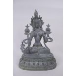 A Tibetan bronze figure of a female deity seated on a lotus throne, 30cm high