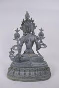 A Tibetan bronze figure of a female deity seated on a lotus throne, 30cm high