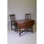 A Victorian oak drop leaf table, raised on barley twist supports and two chairs, 60 x 91 x 73cm