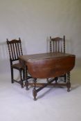 A Victorian oak drop leaf table, raised on barley twist supports and two chairs, 60 x 91 x 73cm