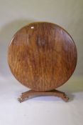 A C19th mahogany tilt top breakfast table, raised on a shaped column and tri-form platform base with