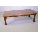 A mid century rosewood coffee table raised on square supports, 70 x 138 x 45cm