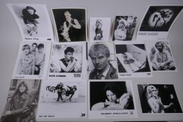 A quantity of black and white press and promotional photographs of musicians including Dolly Parton,