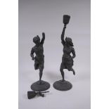 A pair of antique bronzed spelter candlesticks in the form of Moors bearing torcheres, 40cm high, AF