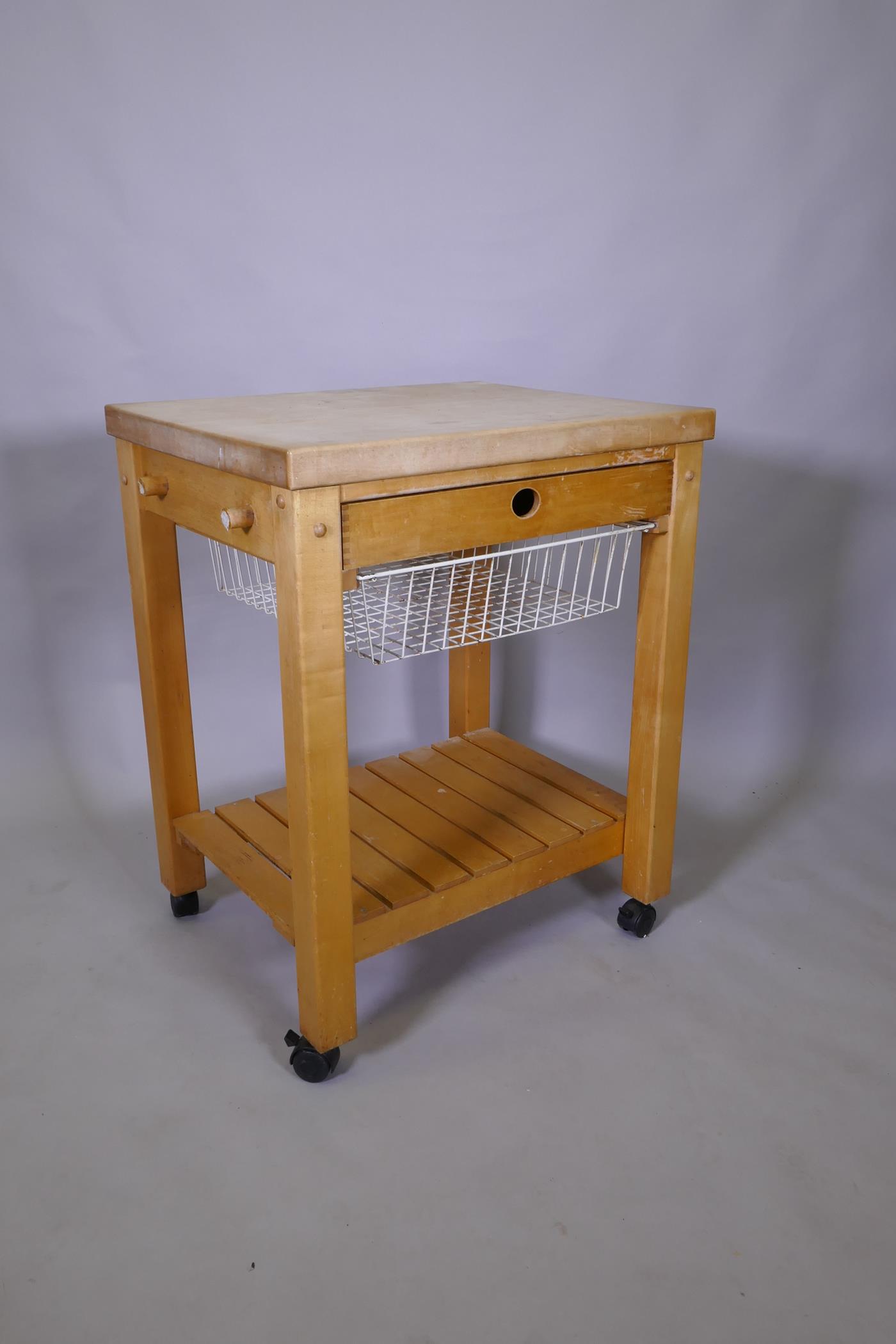 A beech wood kitchen island with chopping block top, single drawer and pull out basket and slatted