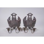 A pair of gothic style bronze two branch wall sconces in the form of bats, 24 x 33cm