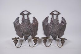 A pair of gothic style bronze two branch wall sconces in the form of bats, 24 x 33cm