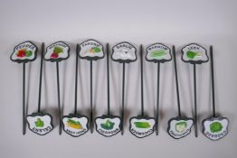 A set of 12 painted cast metal vegetable markers, 32cm long