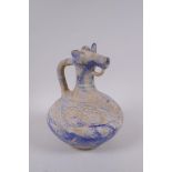 An Islamic blue glazed earthenware ewer with cow mask spout, 22cm high