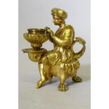 A fine Grand Tour ormolu bronze chamberstick in the form of a page seated upon a dolphin, C18th/