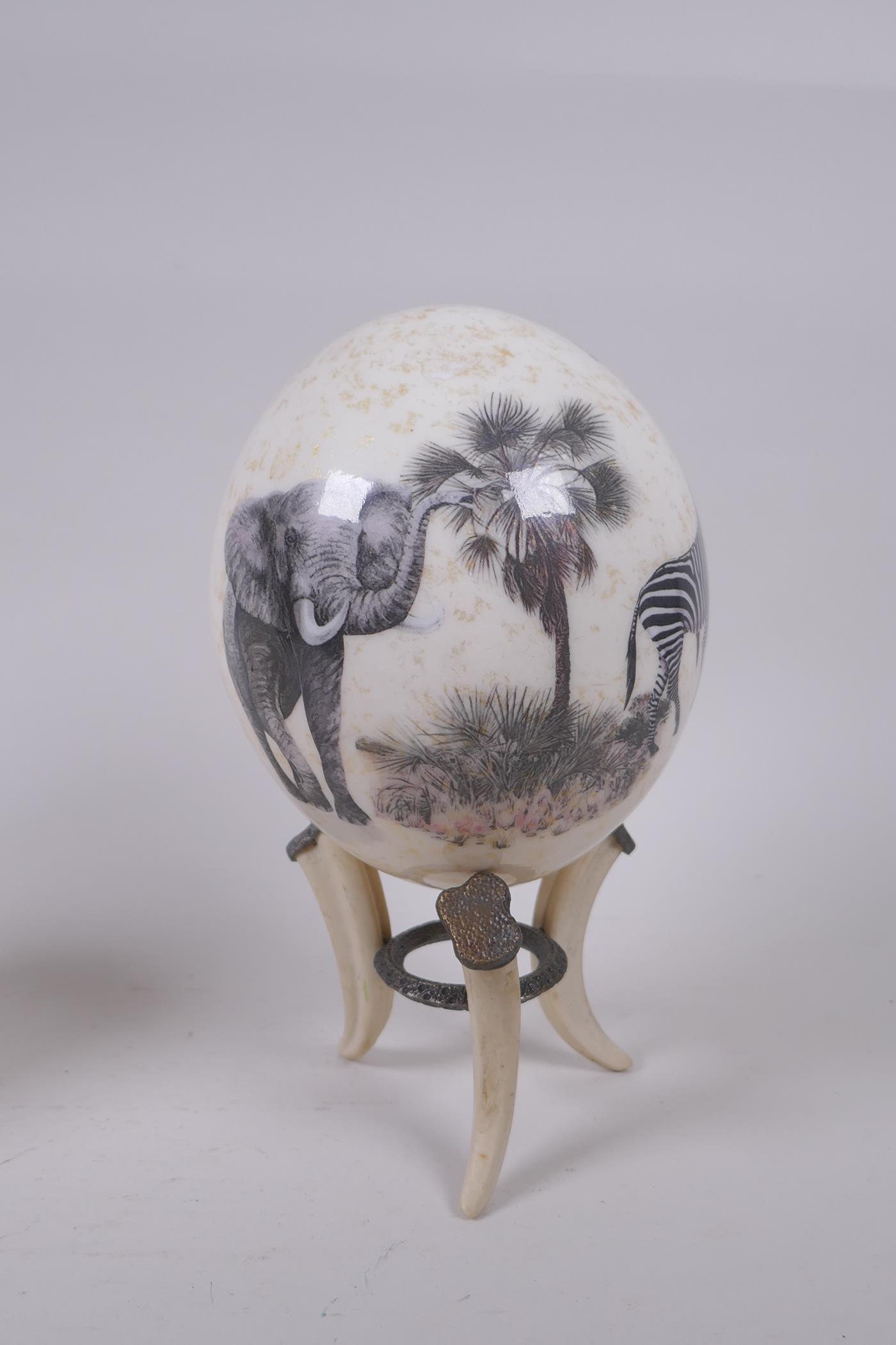 A decorative gilt and collage ostrich egg on stand by Sherry Rowe, and another undecorated ostrich - Image 4 of 7