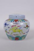 A Chinese Wucai porcelain ginger jar and cover decorated with mythical creatures, character mark