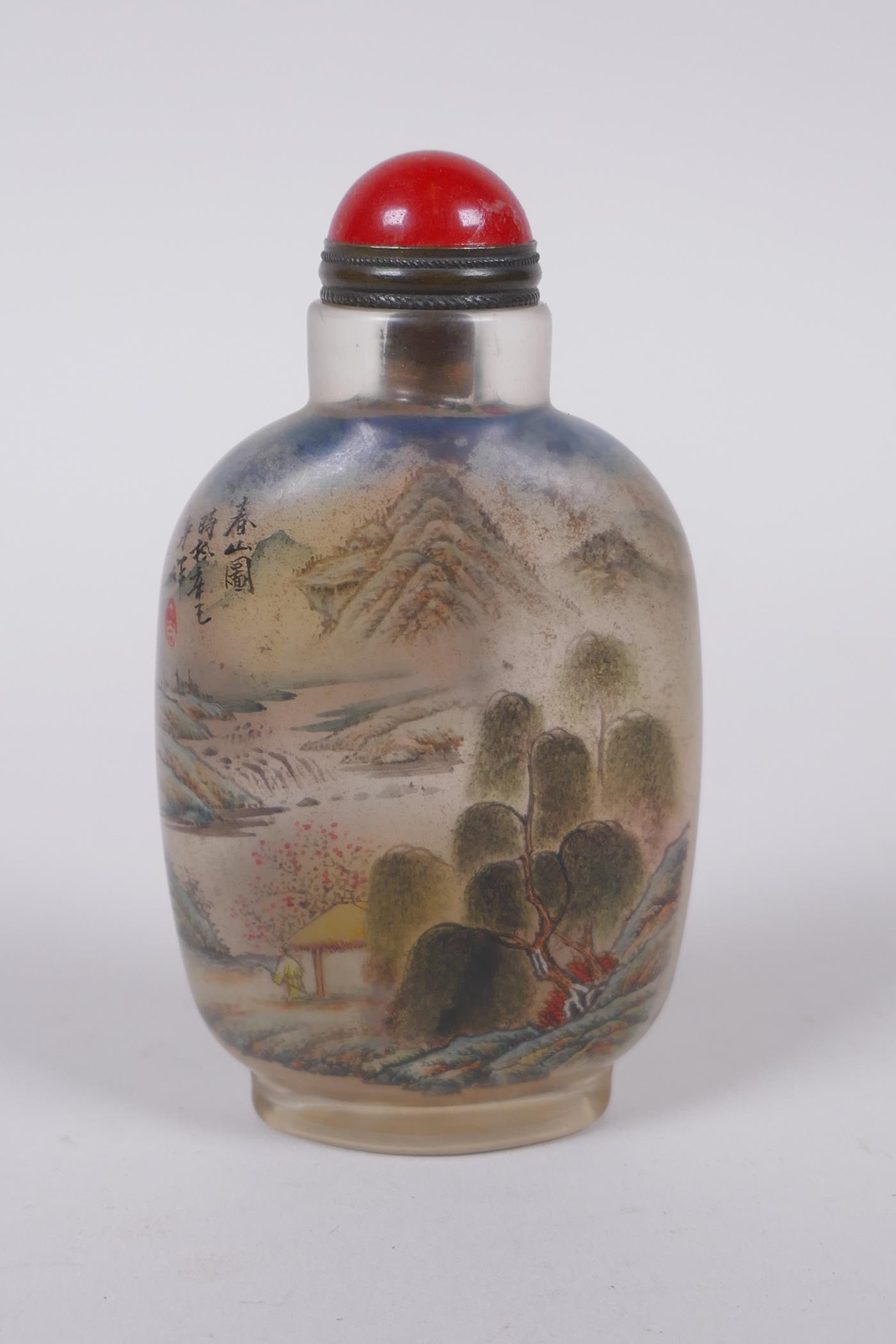 A Chinese reverse decorated glass snuff bottle, depicting figures in a landscape and birds by a lily