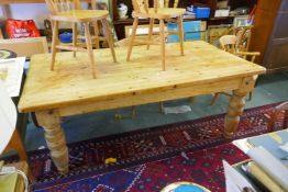 A pine farmhouse table, adapted from a pool table base, and four kitchen chairs, 102 x 200cm