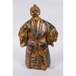 An oriental gilt bronze figure of a bearded gentleman in a long robe, 26cm high