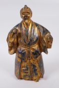 An oriental gilt bronze figure of a bearded gentleman in a long robe, 26cm high