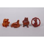 Four Japanese carved boxwood netsuke in the form of a monkey, owl, two frogs, and a seal with