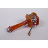 A Tibetan faux amber and white metal prayer wheel set with abalone shards, agate turquoise etc, 17cm