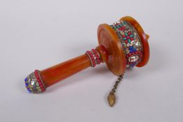 A Tibetan faux amber and white metal prayer wheel set with abalone shards, agate turquoise etc, 17cm