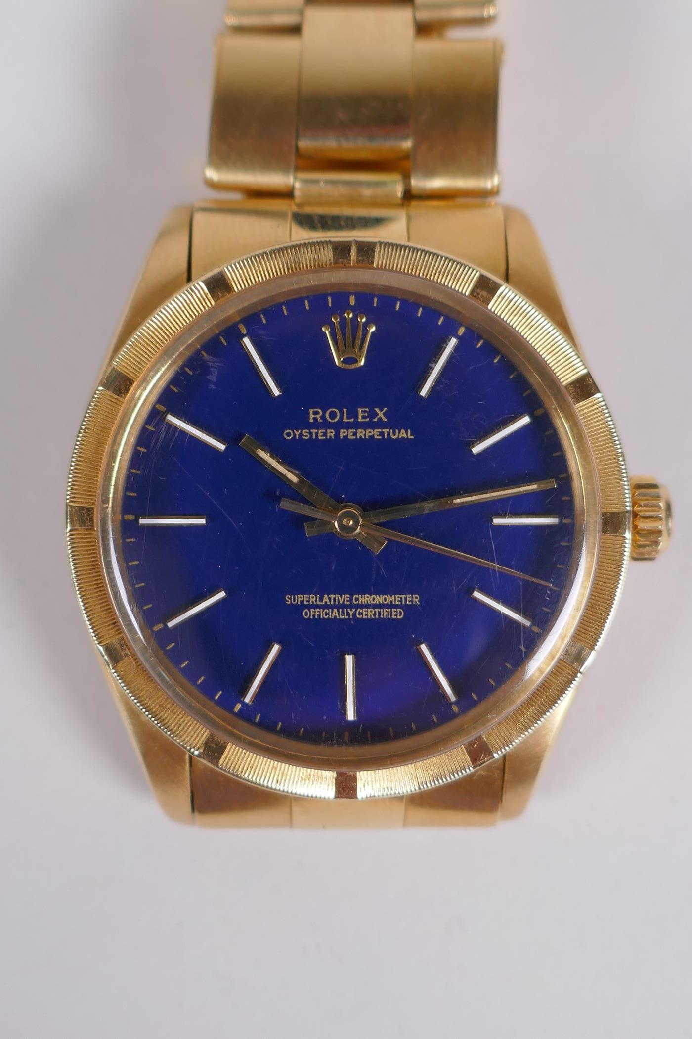 A gentleman's vintage 18ct gold Rolex Oyster Perpetual wrist watch with baton numerals, on a blue