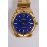 A gentleman's vintage 18ct gold Rolex Oyster Perpetual wrist watch with baton numerals, on a blue