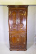 A Georgian painted pine standing corner cupboard in two sections, arched and fielded door panels,