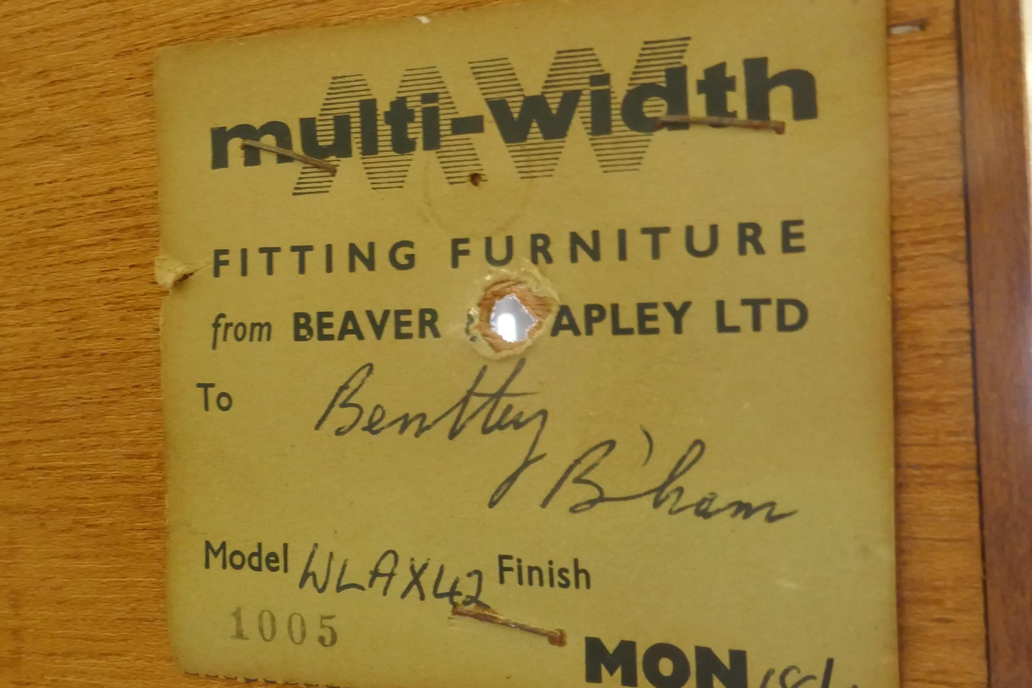 A mid century Beaver & Tapley Ltd multi width teak unit in two sections, the upper with sliding - Image 3 of 3