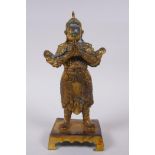 A Chinese gilt bronze figure of a warrior, impressed 4 character mark verso, 23cm high