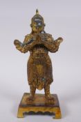 A Chinese gilt bronze figure of a warrior, impressed 4 character mark verso, 23cm high