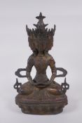 A Tibetan bronze multi headed Buddha with remnants of gilt patina, 31cm high