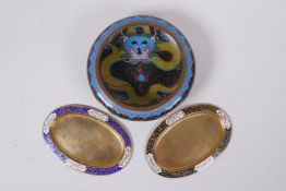 A Chinese black ground cloisonne bowl with rolled rim and dragon decoration, and a pair of Thai oval