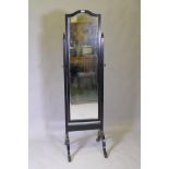 An ebonised frame cheval mirror with brass mounts and bevelled glass, 50 x 52 x 170cm