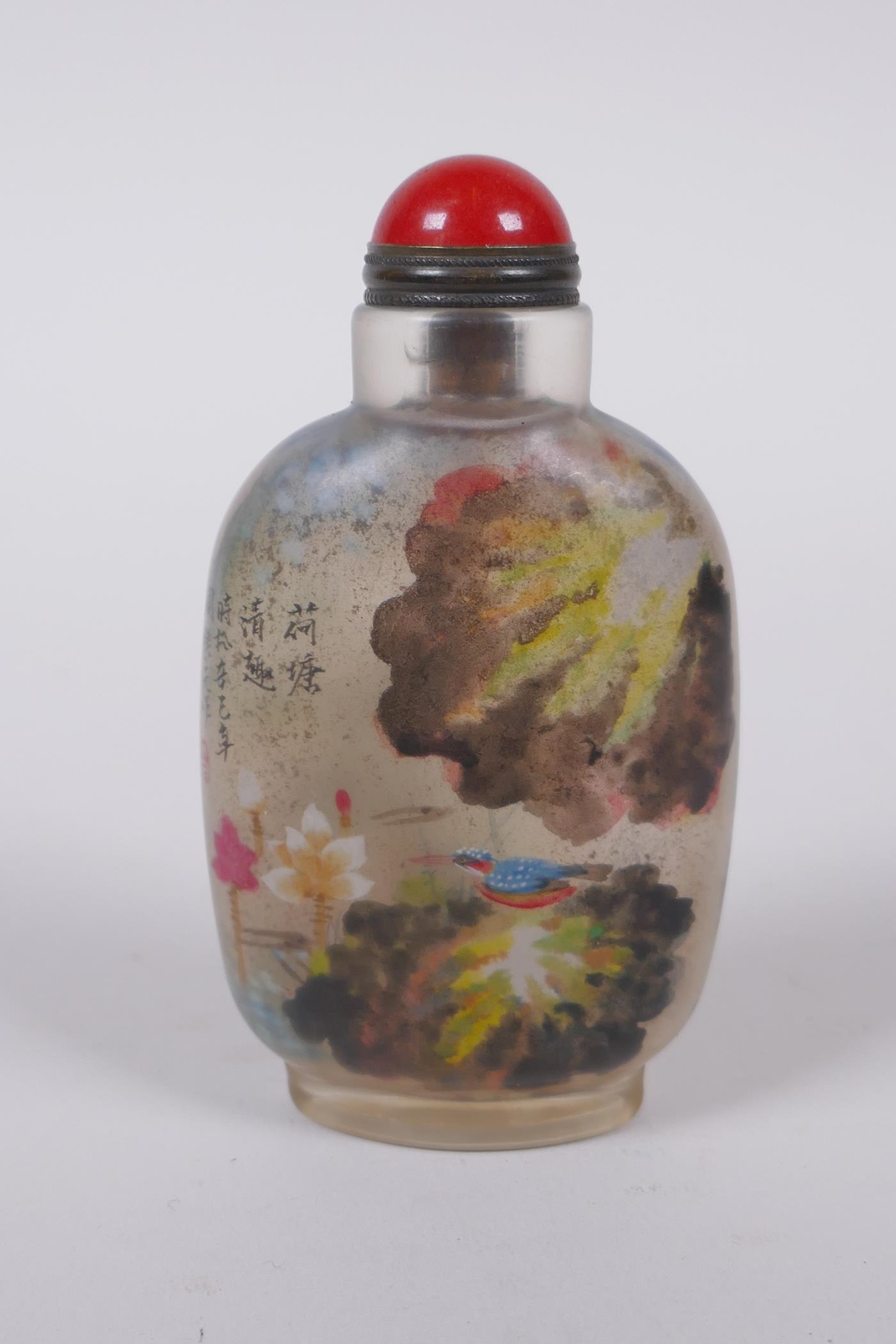 A Chinese reverse decorated glass snuff bottle, depicting figures in a landscape and birds by a lily - Image 2 of 2