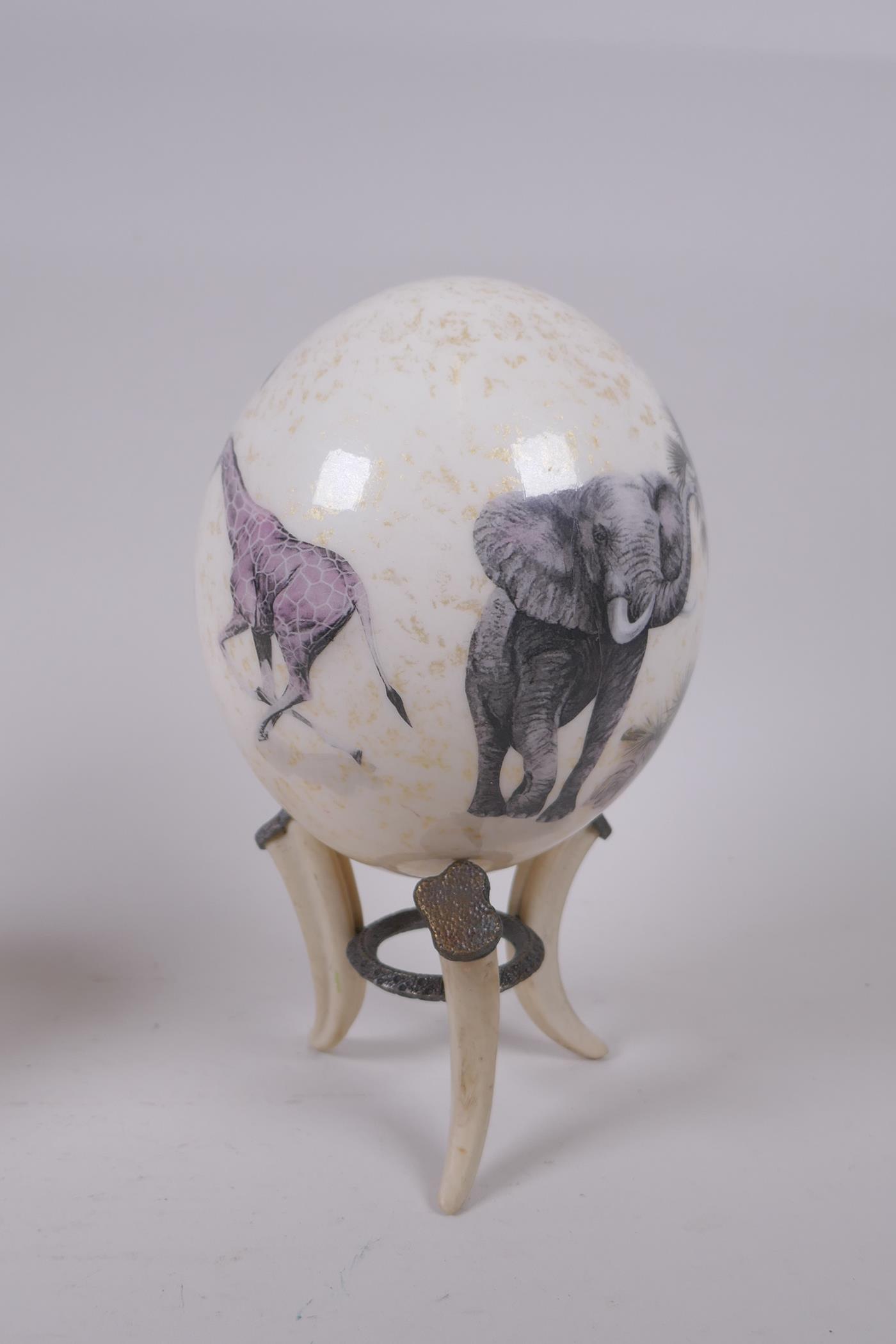 A decorative gilt and collage ostrich egg on stand by Sherry Rowe, and another undecorated ostrich - Image 3 of 7