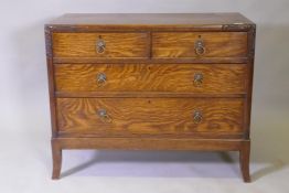 An Arts & Crafts oak chest of two over two drawers, with carved decoration and brass handles, raised