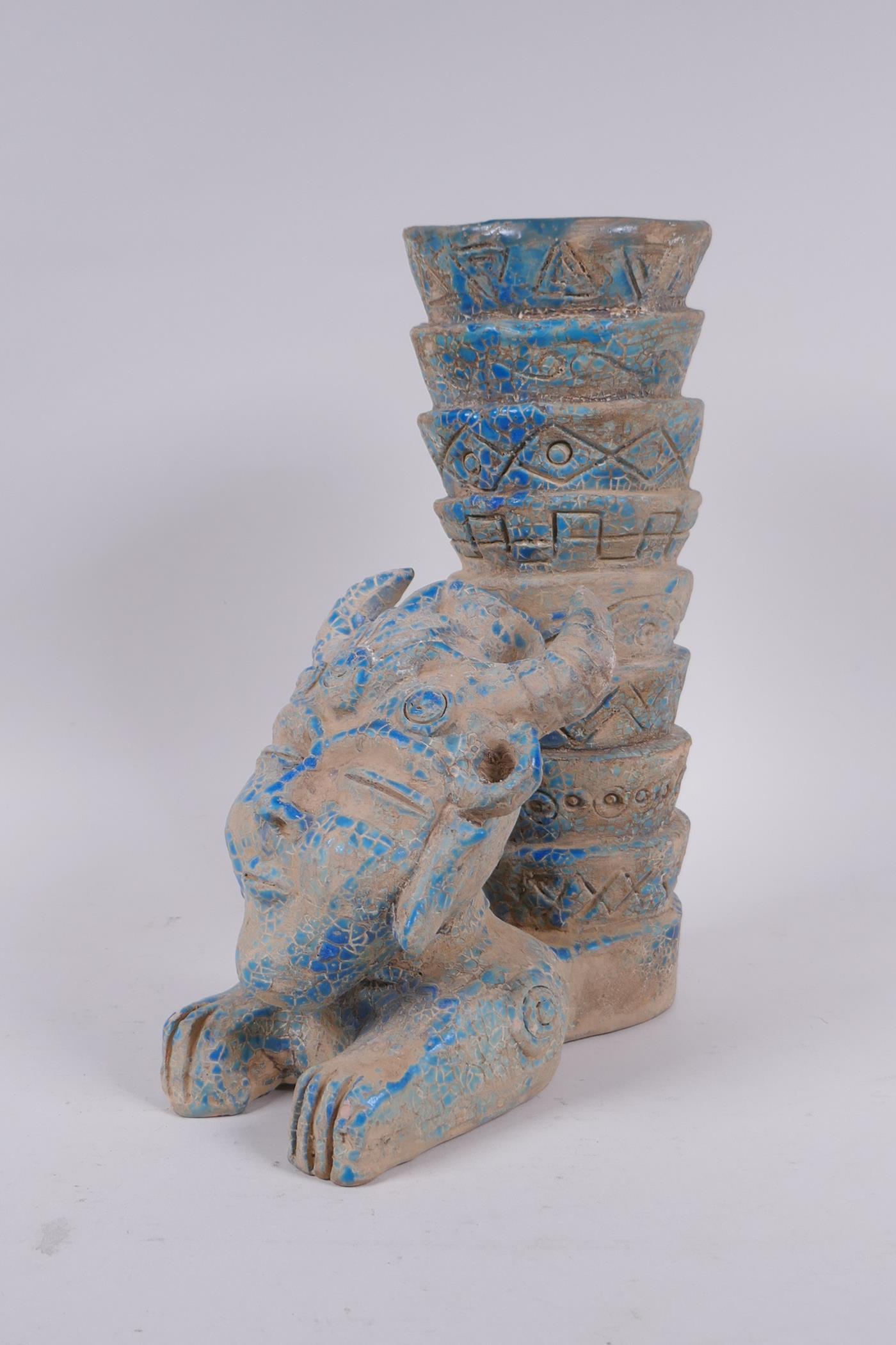 An Islamic earthenware mask vase with turquoise crackle glaze, 25cm high
