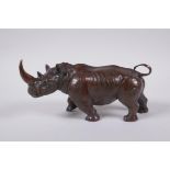 A filled bronze figure of a rhinoceros, 22cm long