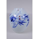 A Japanese Meiji period blue and white porcelain vase decorated with a shrub in bloom, character