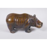 A filled bronze figure of a hippopotamus, 21cm long